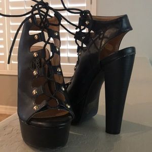 Black lace up heels with gold hardware.